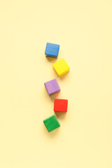 Colorful cubes on beige background. Concept of autistic disorder