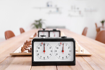 Clock on table in room prepared for chess tournament