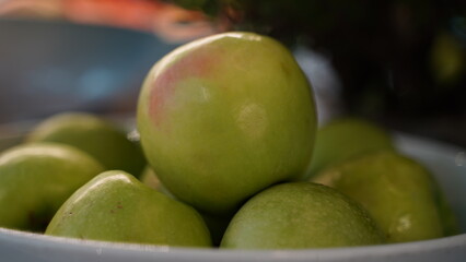 Green Apples on the Plate Close Up