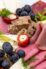 Cold Smoked Meat Plate, antipasto set platter wooden plate. Antipasto board with sliced meat, ham, salami, cheese. Close up