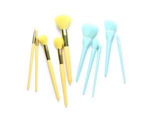 Set of blue and yellow makeup brushes isolated on white, top view