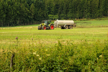 Beautiful shot of a tractor with a fertilizer tank on a farm in a countryside