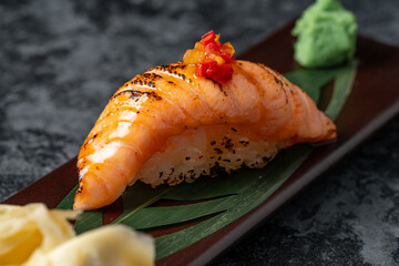 seared sushi nigiri with salmon, fine nigiri sushi on black background