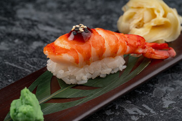 Tiger shrimp sushi on a shiny surface. Japanese kitchen.