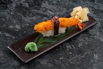 Tiger shrimp sushi on a shiny surface. Japanese kitchen.