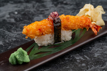 Tiger shrimp sushi on a shiny surface. Japanese kitchen.