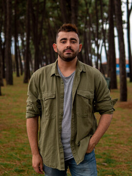 A Caucasian 24 years old male on the beach in Spain with a number of trees in the background