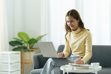 Teen Girl Surfing Internet on Laptop Computer, Sitting on Sofa with Crossed Legs, Free Space