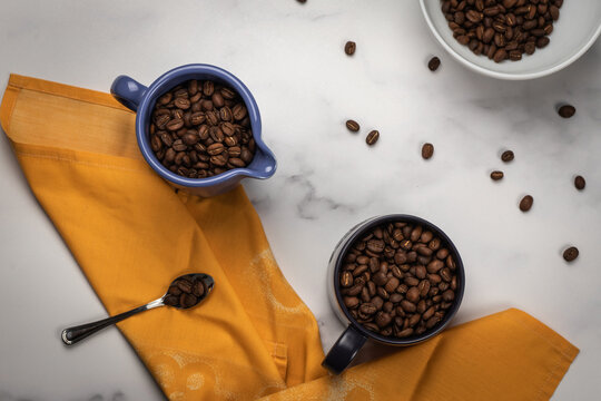 Top View Of A Messy Kitchen Table With Bowls Of Coffee Beans