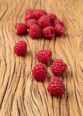 A group of raspberries over wooden table