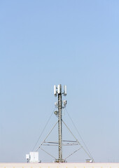 Fototapeta na wymiar 5g mobile telephone relay standing on the roof of a residential building