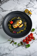 Grilled fish on plate isolated on white background. Cutout and mockup for restaurant menu, top view