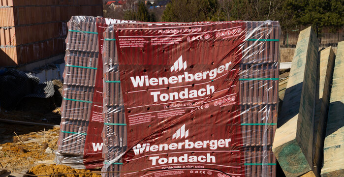 Wienerberger Tondach building material company ceramic roof tiles at construction site of a new single-family house. Unfinished stand-alone home under construction on March 8, 2022 in Krakow, Poland.