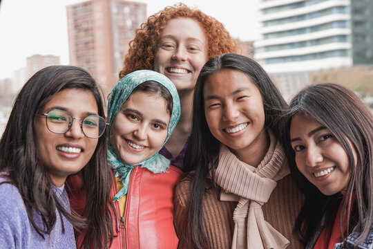 Portrait of young multiracial girls smiling on camera - Different women and friendship concept