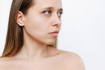 Fototapeta premium Portrait of a young attractive caucasian blonde woman with makeup isolated on a white background.Natural beauty and fashion. Skin care