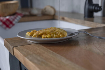Shot of cooked egg in white dish on wooden table