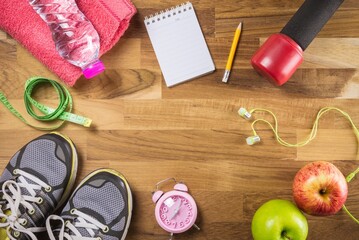 Sport and fitness objects and space small notepad on wooden background copy space - Exercise, Health care and diet target plan concept.