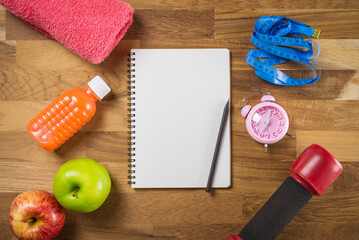 Sport and fitness objects and space notepad on wooden background - Exercise, Health care and diet target plan concept.