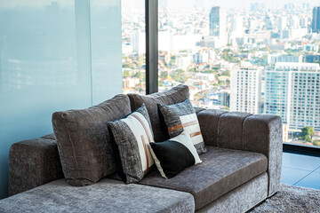 The interior design of the glass room on the condo Can see the view outside, with sofas and pillows for relaxing.