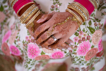 Closeup of beautiful henna on the bride's hands at a traditional Indian wedding celebration