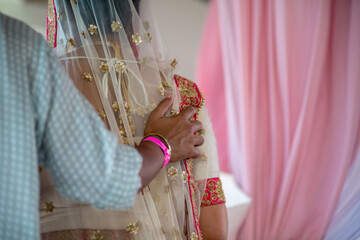 Closeup of a father walking his daughter at a traditional Indian wedding ceremony