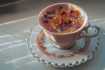 Floral natural tea in a pink cup on a saucer. High quality photo