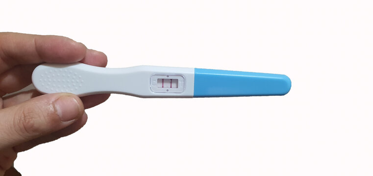 Female Hand Holding Pregnancy Test On A White Background