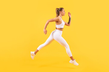 Fototapeta na wymiar sport woman runner running on yellow background