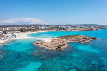 Fototapeta na wymiar Nissi Beach in Ayia Napa, clean aerial photo of famous tourist beach in Cyprus, the place is a known destination on island and is formed from a smaller island just near the main shore