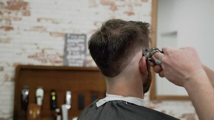 Man barber cutting hair of male client with clipper at barber shop. Hairstyling process. Slow motion Close up. High quality FullHD footage