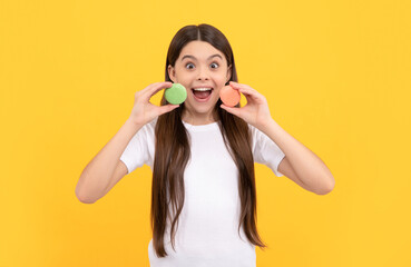 happy amazed child with dessert bakery. kid hold french macaron. macaroon cookie.