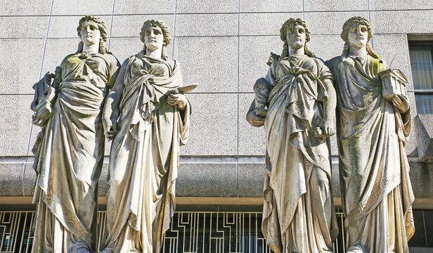 D&uuml;sseldorf, Germany - March 23. 2022: View on ancient 4 caryatid sculptures representing 4 arts, wall background