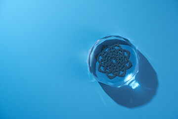 crystal paperweight against blue background