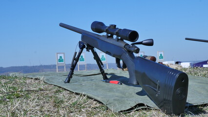 Modern powerful sniper rifle with telescopic view mounted on a bipod. Ammunition by rifle.