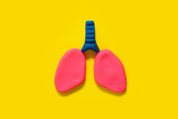 lungs symbol on a yellow background made with plasticine concept of world tuberculosis day, world no tobacco day, lung cancer, Pulmonary hypertension, Pneumonia, copd, eco air pollution. copy space