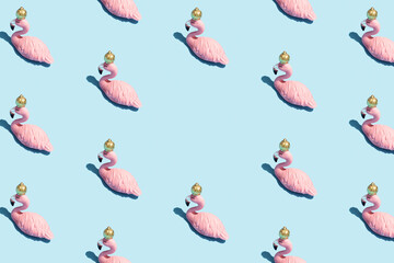 Trendy sunlight Summer pattern made with pink flamingo toy on bright light blue background. Minimal summer concept.