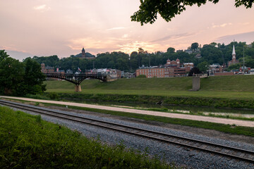 Railroad along by the river and grant park pedestrian bridge at sunset, Galena, Illinois