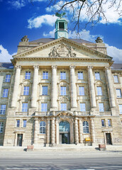 Düsseldorf (Bezirksregierung), Germany - March 21.2022: View on neo baroque front facade of local gevernment president palace against blue sky, fluffy clouds