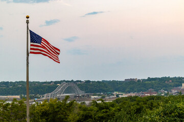 American flag and Julien Dubuque Bridge against blue sky in Dubuque city, Iowa, United States