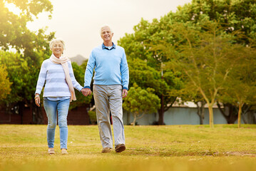 Strolling through the park. Portrait of a senior couple enjoying a walk together in a park.