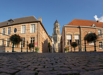 Low angle photo of cobblestone street and Saint Gummarus Church in Lier, Belgium