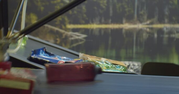 plastic bottles and paper packaging move along a sorting line conveyor at a recycling plant.close-up.
