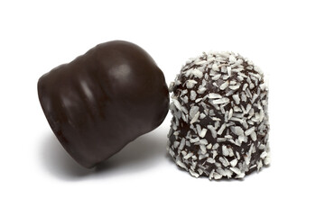two chocolate marshmallows leaning against white background