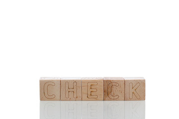 Wooden cubes with letters check on a white background