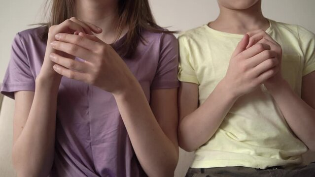 Little boy and teenage girl practicing EFT or emotional freedom technique - tapping on the side of hand, slow motion