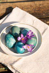 Blue Easter eggs with purple crocuses