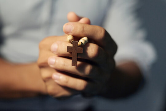 Speaking to a higher power. Cropped shot of a mans hands holding a rosary.