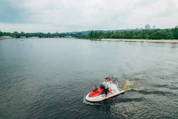 Aerial view of a couple on a jet ski. Happy young couple on a jet ski having fun