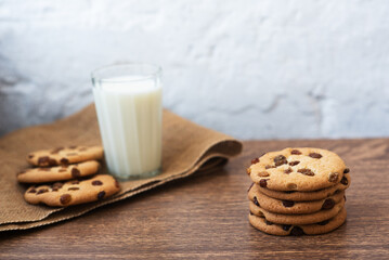 Fragrant, tasty, homemade cookies with raisins and a glass of fresh milk on the table. Delicious, hearty, healthy breakfast. Copy space, high resolution