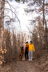 Playing with the dog together in the forest while having fun